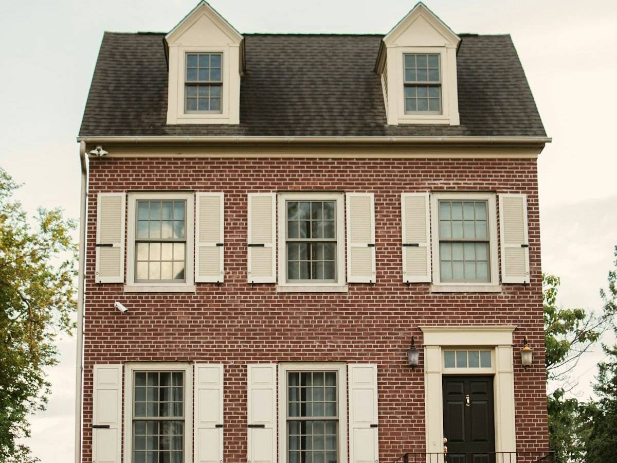 Completed gutter and roof project on red brick house